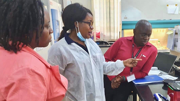 (Photo: Damalie Nakanjako with her trainees, in the translation lab at Makerere University College of Health Sciences)