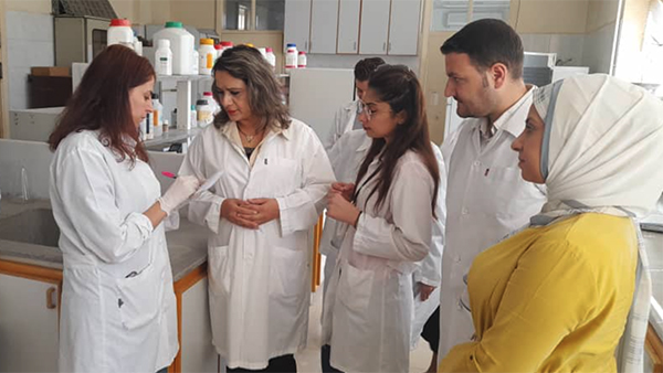 (Photo: Nadia Haider briefing trainees, in a laboratory, in the Department of Molecular Biology and Biotechnology, Atomic Energy Commission of Syria, in Damascus, Syria)